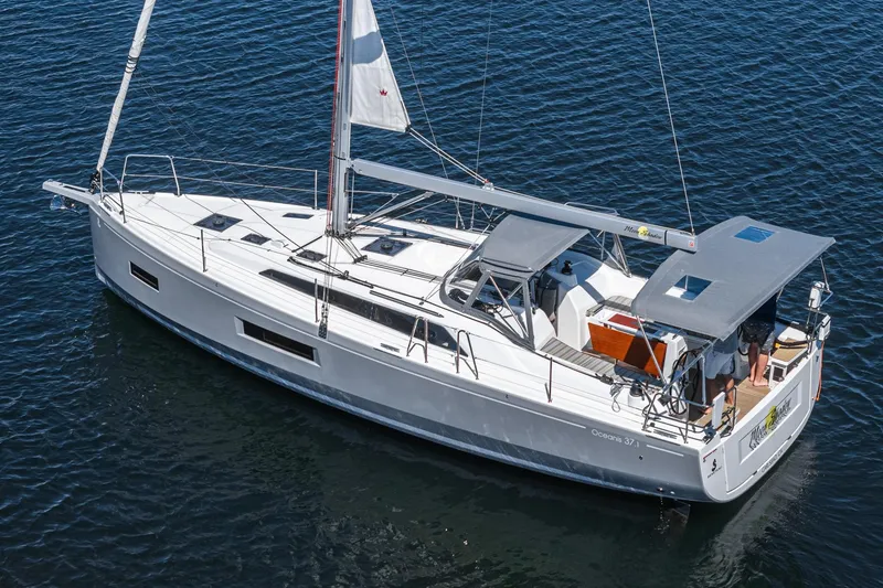 Slide: The Image of 2025 Beneteau Oceanis 37.1 sailboat on calm water, showcasing sleek design and modern features. - 40