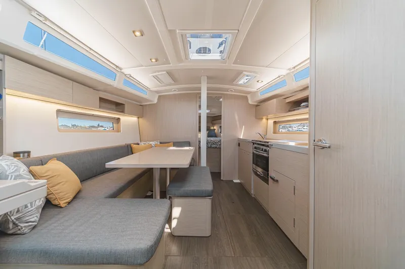 Slide: The Image of 2025 Beneteau Oceanis 37.1 yacht interior with modern kitchen and dining area. - 5