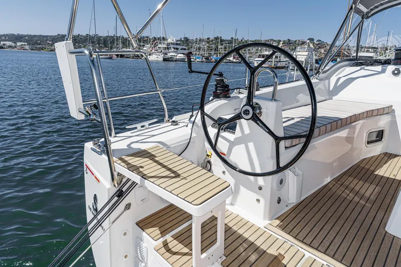 Slide: The Image of 2025 Beneteau Oceanis 37.1 yacht cockpit with steering wheel, docked in marina. - 64