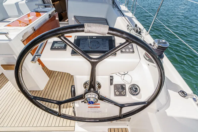 Slide: The Image of Steering wheel of 2025 Beneteau Oceanis 37.1 yacht with navigation instruments. - 68