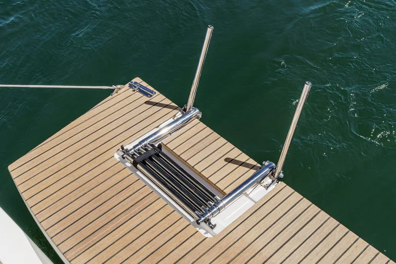 Slide: The Image of 2025 Beneteau Oceanis 37.1 swim platform with stainless steel ladder on calm water. - 73