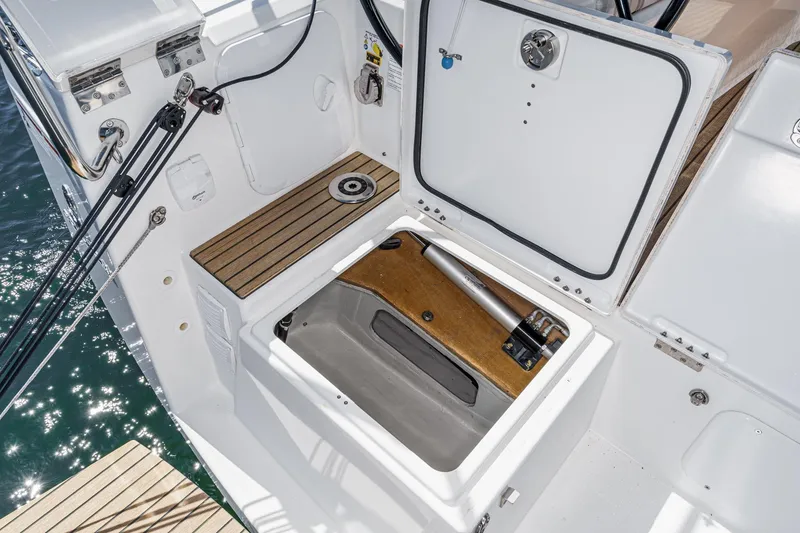 Slide: The Image of 2025 Beneteau Oceanis 37.1 yacht storage compartment with open hatch and visible hydraulic system. - 75