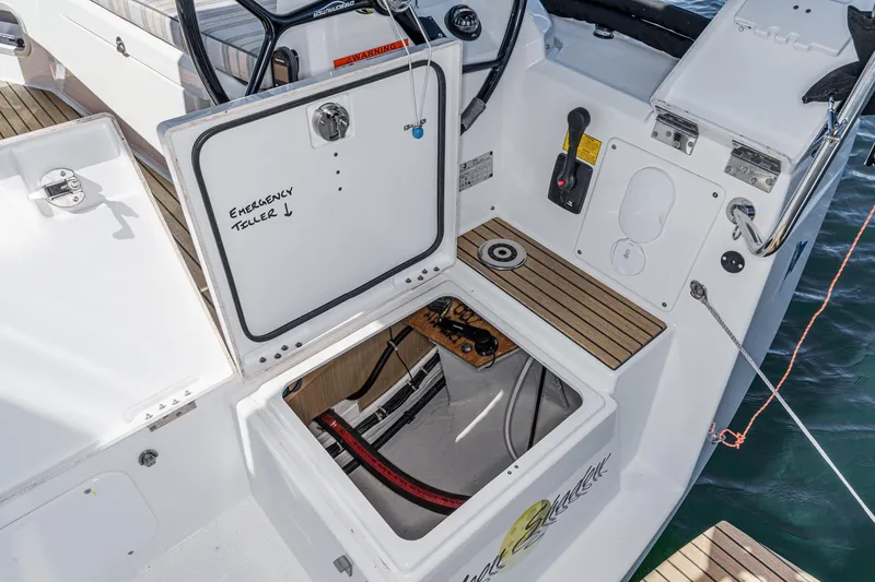 Slide: The Image of 2025 Beneteau Oceanis 37.1 yacht cockpit with open emergency tiller compartment. - 76