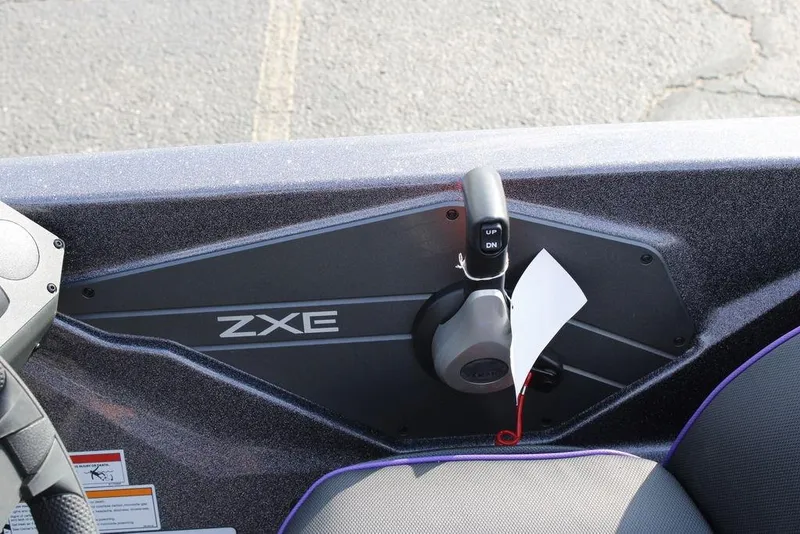 Slide: The Image of Control panel of 2026 Skeeter ZXE21 boat with throttle lever and label. - 20