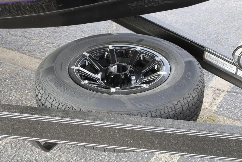 Slide: The Image of Spare tire on a 2026 Skeeter ZXE21 trailer, featuring a black alloy wheel. - 22