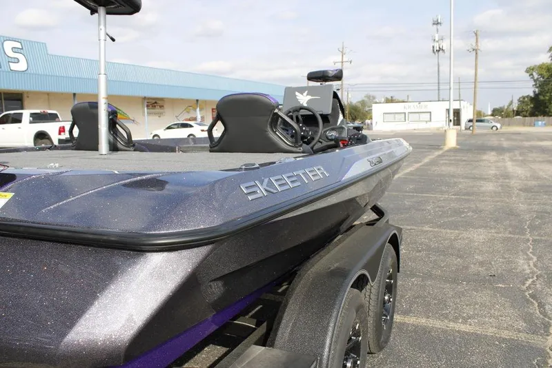 Slide: The Image of 2026 Skeeter ZXE21 boat in parking lot, showcasing sleek design and modern features. - 8