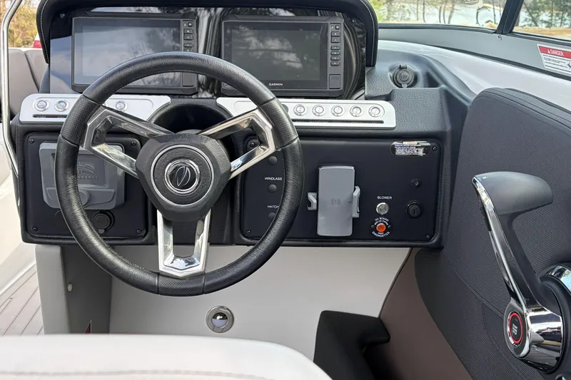 Slide: The Image of Steering wheel and dashboard of 2026 Crownline 240 SS boat with modern controls. - 5