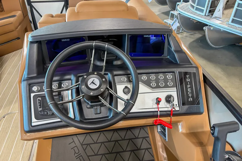 Slide: The Image of 2026 Trifecta 23 RF SS boat dashboard with steering wheel and control panel. - 7