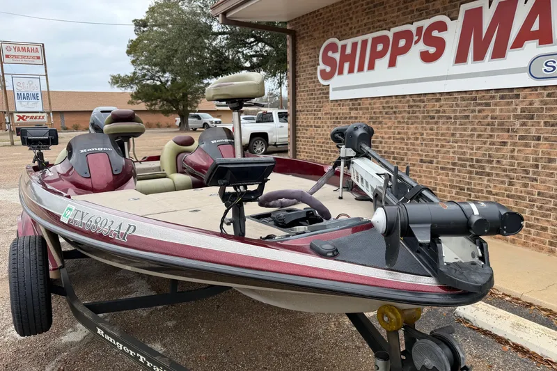 Slide: The Image of 2008 Ranger 188 VX boat parked outside Shipp's Marine, featuring maroon and beige seating. - 2