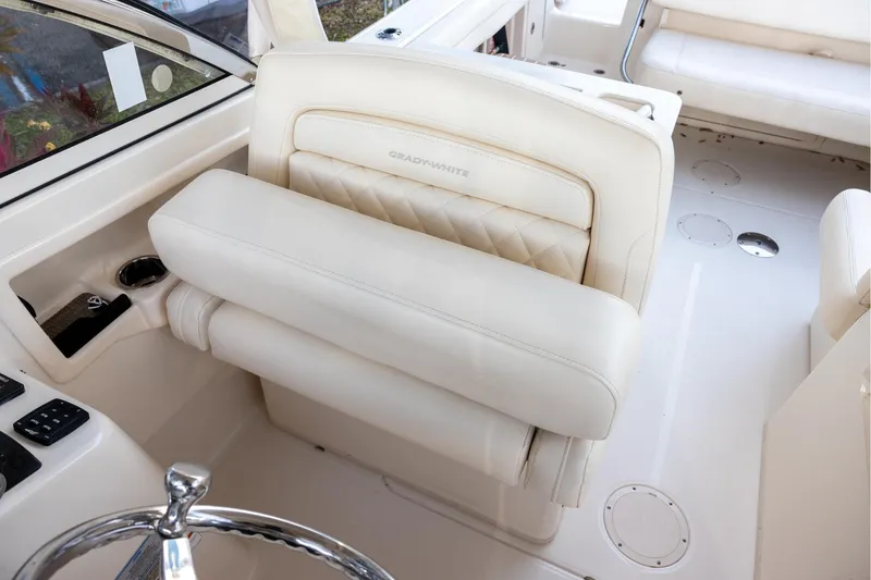 Slide: The Image of 2018 Grady-White Freedom 285 boat interior with luxurious seating and steering wheel. - 13