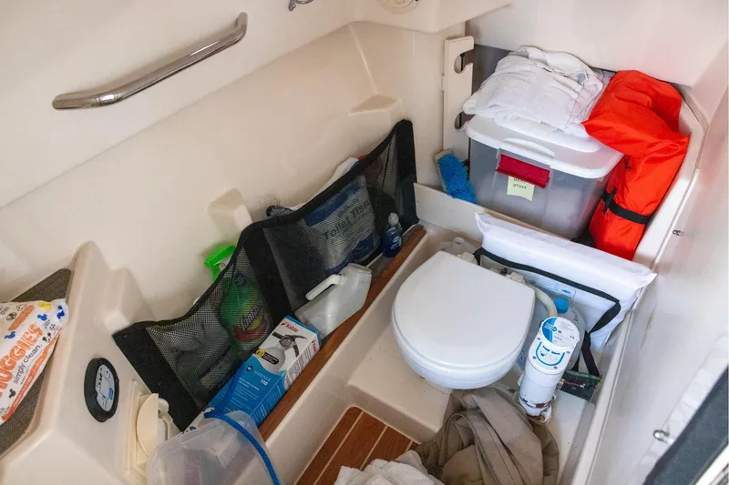 Slide: The Image of 2018 Grady-White Freedom 285 boat interior with toilet and storage area. - 15