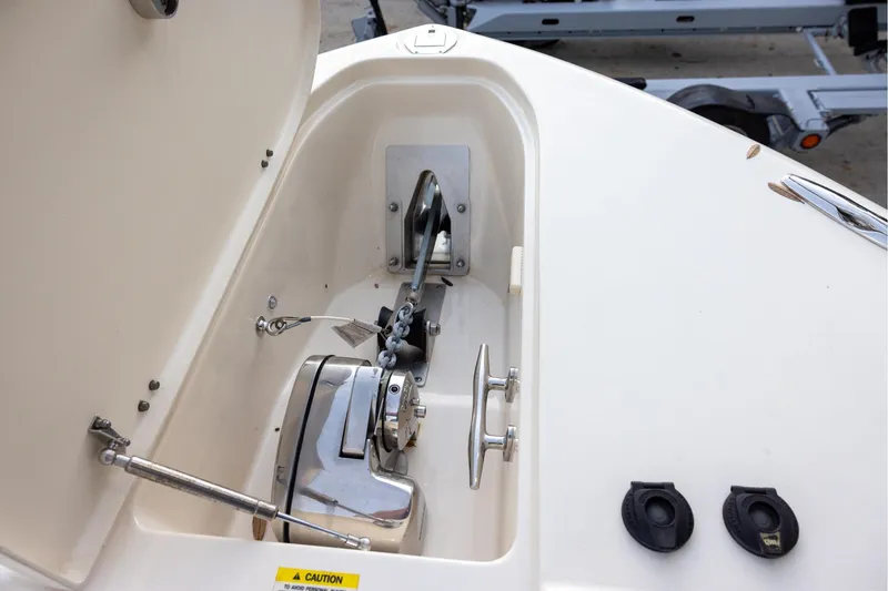 Slide: The Image of Anchor compartment of 2018 Grady-White Freedom 285 boat, featuring winch and cleat. - 18