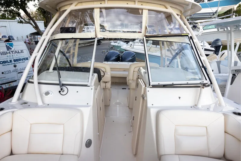 Slide: The Image of 2018 Grady-White Freedom 285 boat interior with seating and windshield, docked at marina. - 19