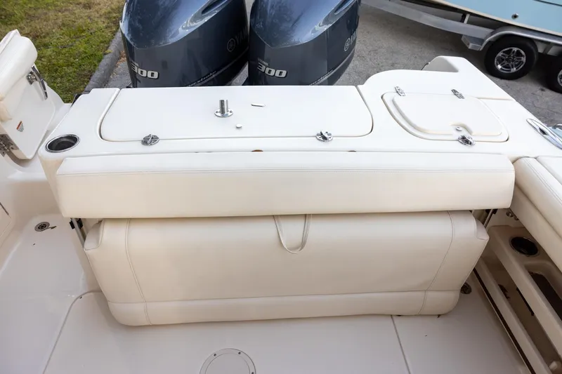 Slide: The Image of 2018 Grady-White Freedom 285 boat interior with Yamaha engines, featuring white seating and storage compartments. - 7