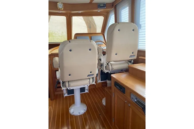 Slide: The Image of Interior of 2010 Sabre 38 Express yacht with beige captain chairs and wooden accents. - 13