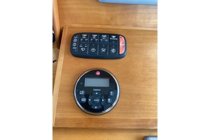 Slide: The Image of Control panel and remote on Sabre 38 Express 2010 boat dashboard. - 17