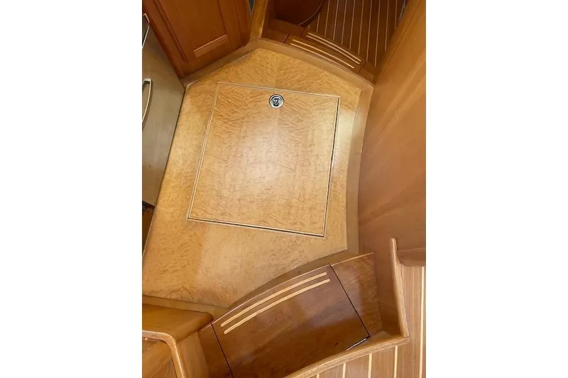 Slide: The Image of 2010 Sabre 38 Express interior with wooden flooring and storage compartment. - 18