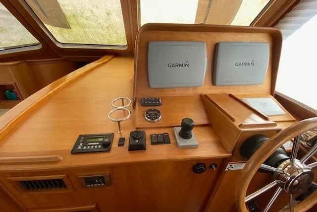 Slide: The Image of Helm of 2010 Sabre 38 Express with Garmin navigation displays and controls. - 21