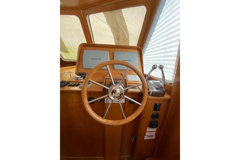 Slide: The Image of Steering wheel and controls of 2010 Sabre 38 Express boat with Garmin displays. - 22