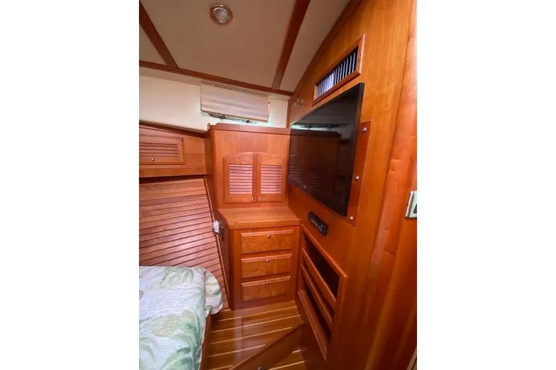 Slide: The Image of Interior of 2010 Sabre 38 Express yacht with wooden cabinetry and built-in TV. - 26