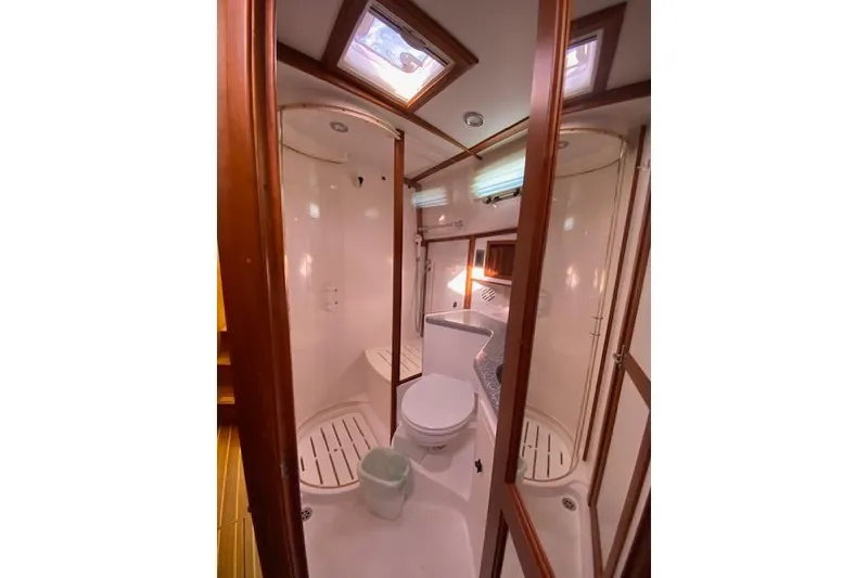 Slide: The Image of 2010 Sabre 38 Express yacht bathroom with shower, toilet, and wooden accents. - 29