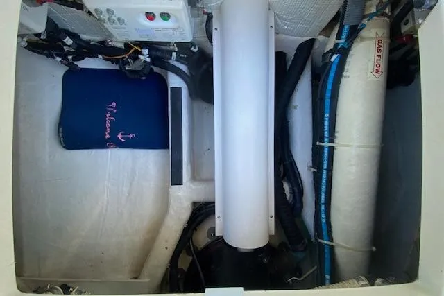 Slide: The Image of Engine compartment of a 2010 Sabre 38 Express boat, featuring various mechanical components. - 32