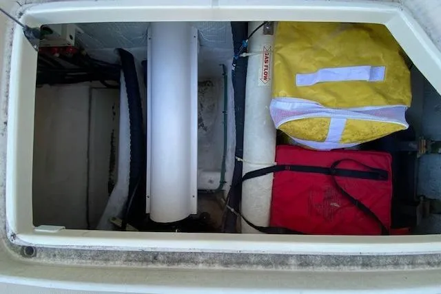 Slide: The Image of Storage compartment of 2010 Sabre 38 Express with safety gear and equipment. - 33