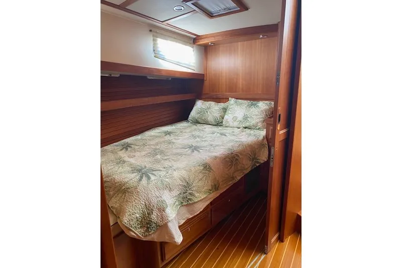 Slide: The Image of Cozy cabin interior of 2010 Sabre 38 Express with wooden finish and floral bedding. - 37