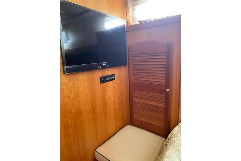 Slide: The Image of Interior of 2010 Sabre 38 Express with TV and wooden cabinet. - 38
