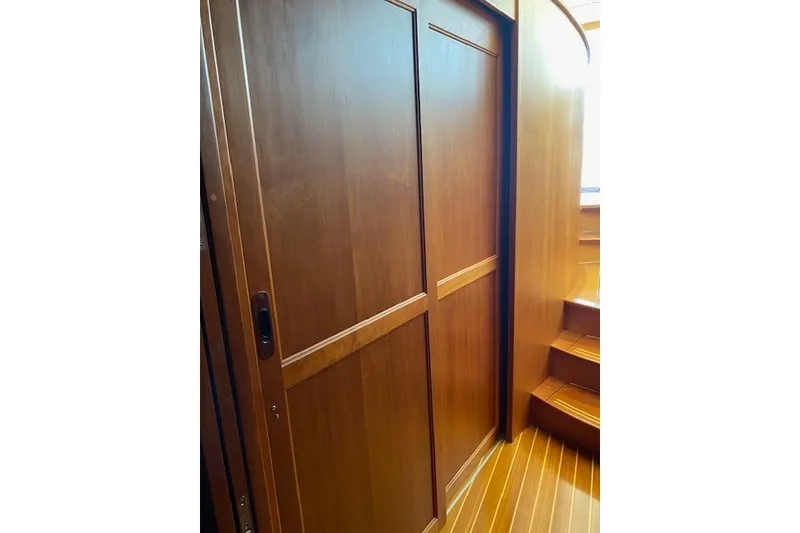 Slide: The Image of Wooden interior of 2010 Sabre 38 Express yacht, featuring a sliding door and steps. - 39