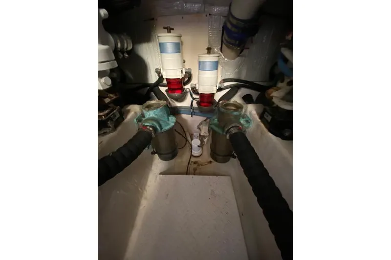 Slide: The Image of Engine room of 2010 Sabre 40 Sedan with filters and hoses visible. - 52