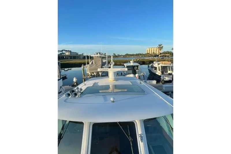 Slide: The Image of 2010 Sabre 40 Sedan yacht docked at marina under clear blue sky. - 59