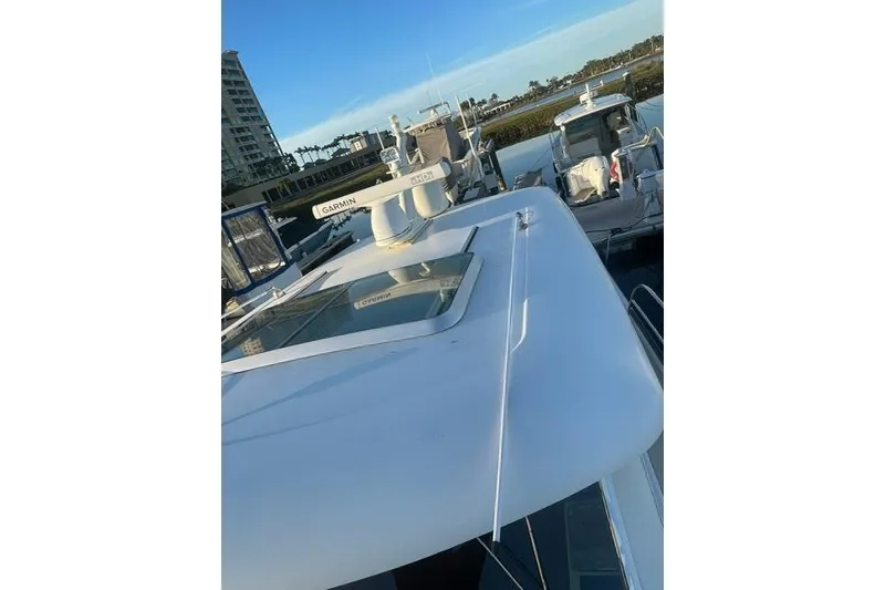 Slide: The Image of 2010 Sabre 40 Sedan yacht docked, featuring sleek design and advanced Garmin navigation system. - 60