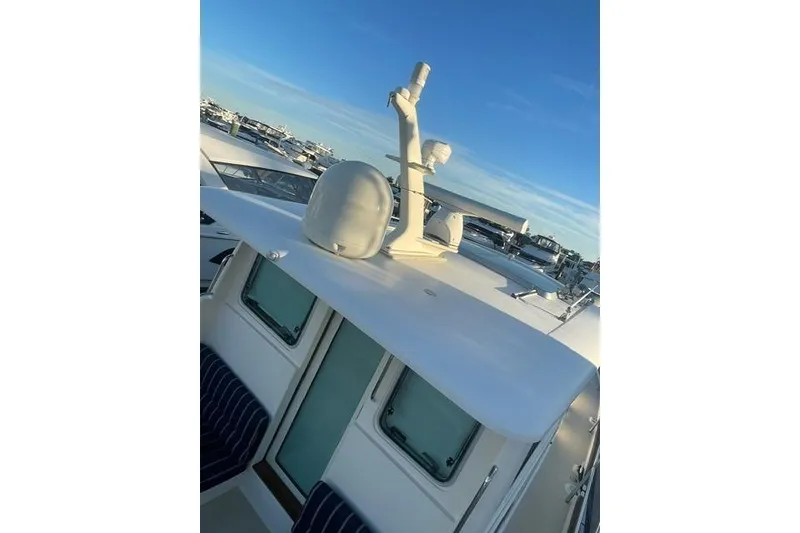 Slide: The Image of 2010 Sabre 40 Sedan yacht with radar equipment on deck, docked at marina. - 63