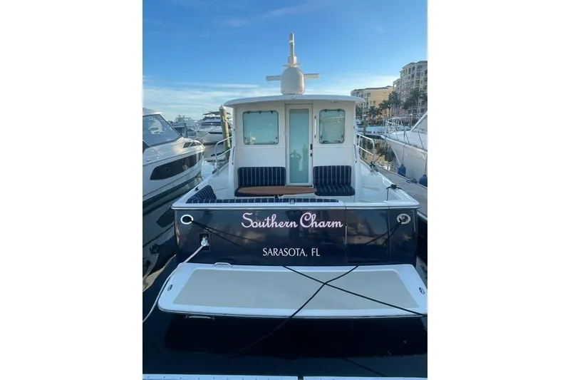 Slide: The Image of 2010 Sabre 40 Sedan yacht docked, named "Southern Charm," in Sarasota, FL marina. - 64