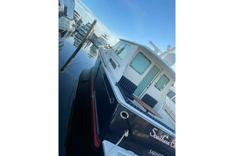 Slide: The Image of 2010 Sabre 40 Sedan yacht docked in marina, featuring sleek design and spacious deck. - 65