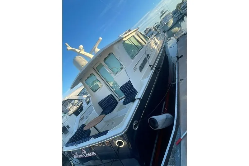 Slide: The Image of 2010 Sabre 40 Sedan yacht docked, featuring a sleek design and comfortable seating. - 66