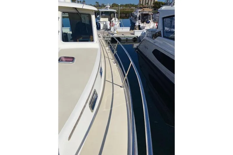 Slide: The Image of 2010 Sabre 40 Sedan yacht docked at marina, side view with railing. - 69
