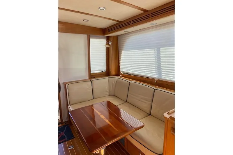 Slide: The Image of 2010 Sabre 40 Sedan interior with beige seating and wooden table. - 75