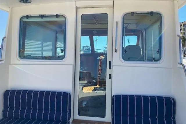 Slide: The Image of 2010 Sabre 40 Sedan yacht with striped seating and glass door. - 77