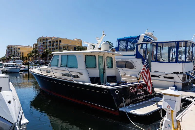 Slide: The Image of Engine room of a 2010 Sabre 40 Sedan with complex piping and machinery. - 84
