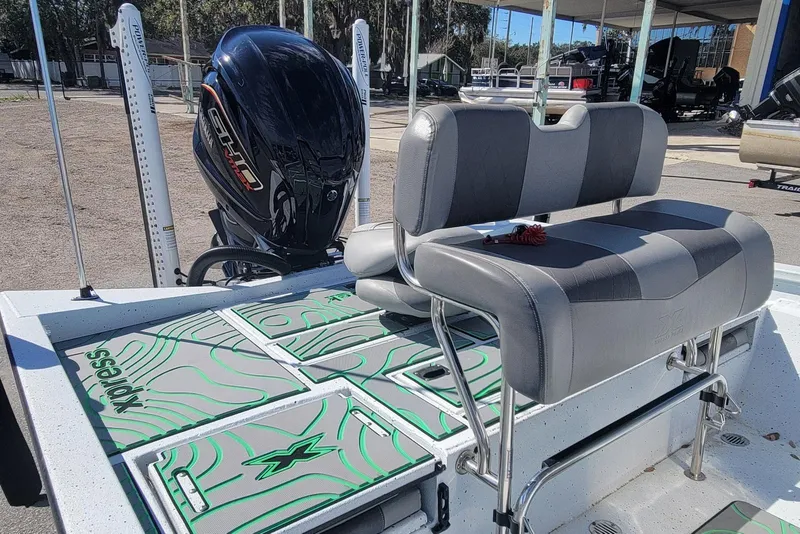 Slide: The Image of 2024 Xpress H22B Bay boat interior with seating and motor, showcasing modern design. - 10