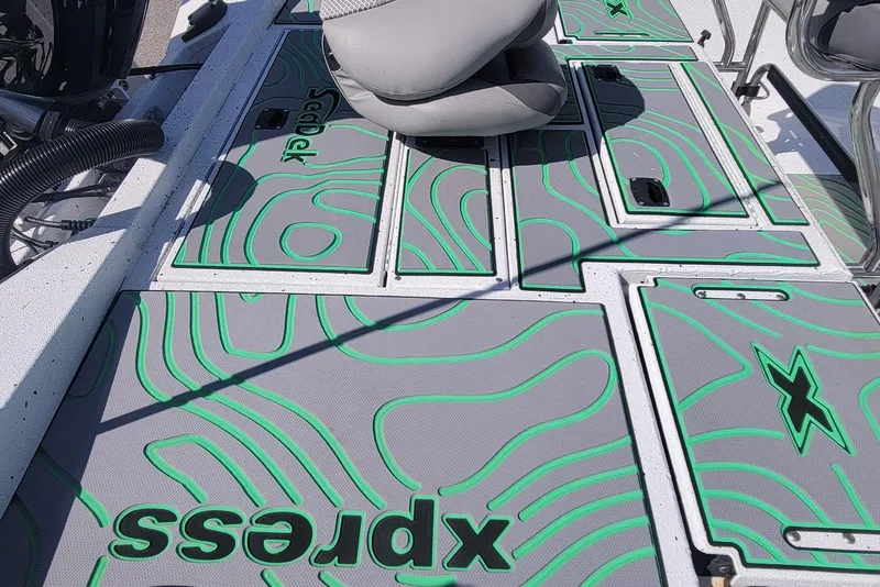 Slide: The Image of 2024 Xpress H22B Bay boat deck with custom green and gray design. - 11