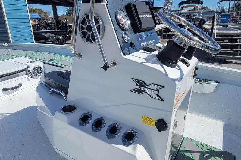 Slide: The Image of 2024 Xpress H22B Bay boat console with steering wheel and controls. - 17