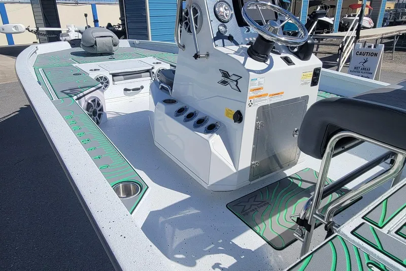 Slide: The Image of 2024 Xpress H22B Bay boat interior with steering console and seating. - 18