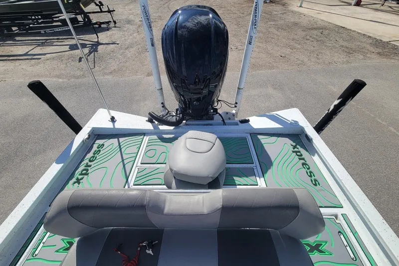 Slide: The Image of 2024 Xpress H22B Bay boat interior with seating and motor, featuring green accents. - 7