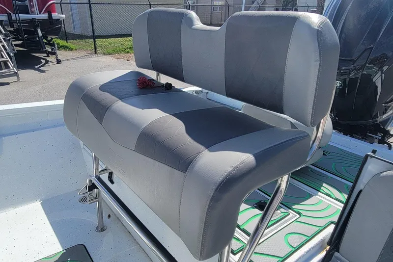 Slide: The Image of 2024 Xpress H22B Bay boat with gray seating and stainless steel frame. - 8