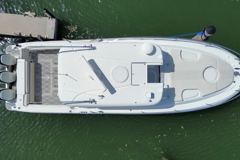 Slide: The Image of Aerial view of 2006 Hydra-Sports Vector 3300 VX boat docked on green water. - 31