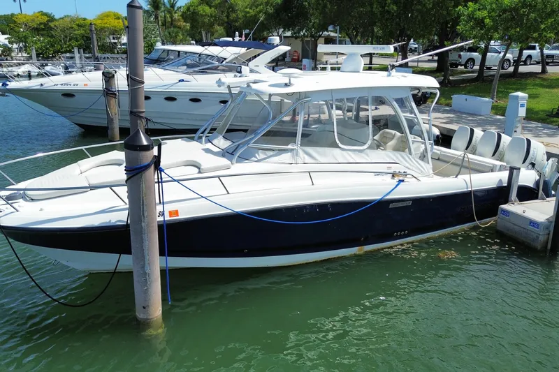 Slide: The Image of 2006 Hydra-Sports Vector 3300 VX boat docked in marina, featuring sleek design and powerful engines. - 6