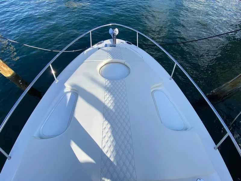 Slide: The Image of 2006 Hydra-Sports Vector 3300 VX boat deck, featuring sleek design and water reflections. - 11